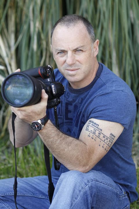 Panama, Bocas del Toro, Man with camera and camera tattoo on the arm stock  photo