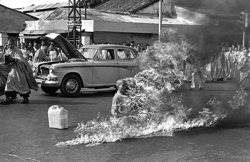 Black and white shot of a monk on fire