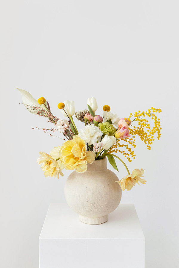 bouquet of yellow flowers in round white vase still life flower