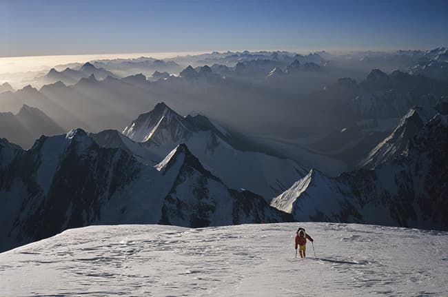 Mountain photographer Alan Hinkes - Early morning, setting off from the Shoulder at over 8000m on K2. A Dutch climber follows me up towards the Bottleneck