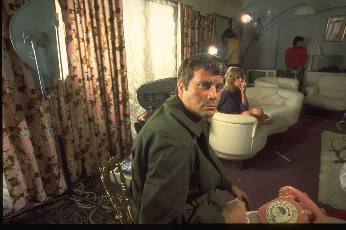 Actor Oliver Reed takes a break from filming