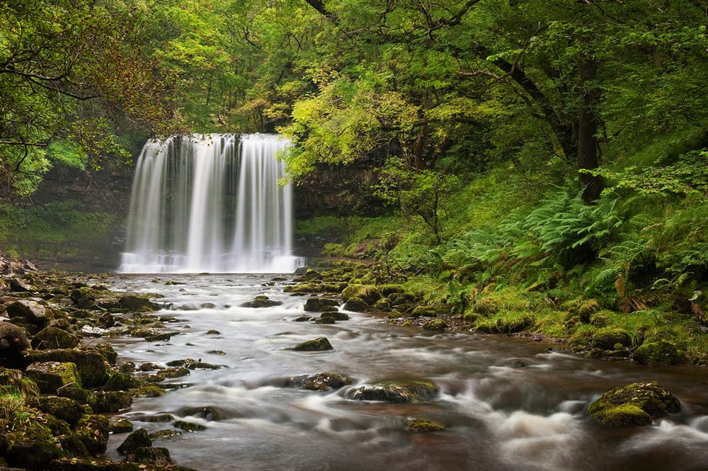 Be careful when shooting as the slippery surfaces can be dangerous. Sgwd yr Eira waterfall, Brecon Beacons National Park, Wales. Autumn. Photo: Jeremy Walker