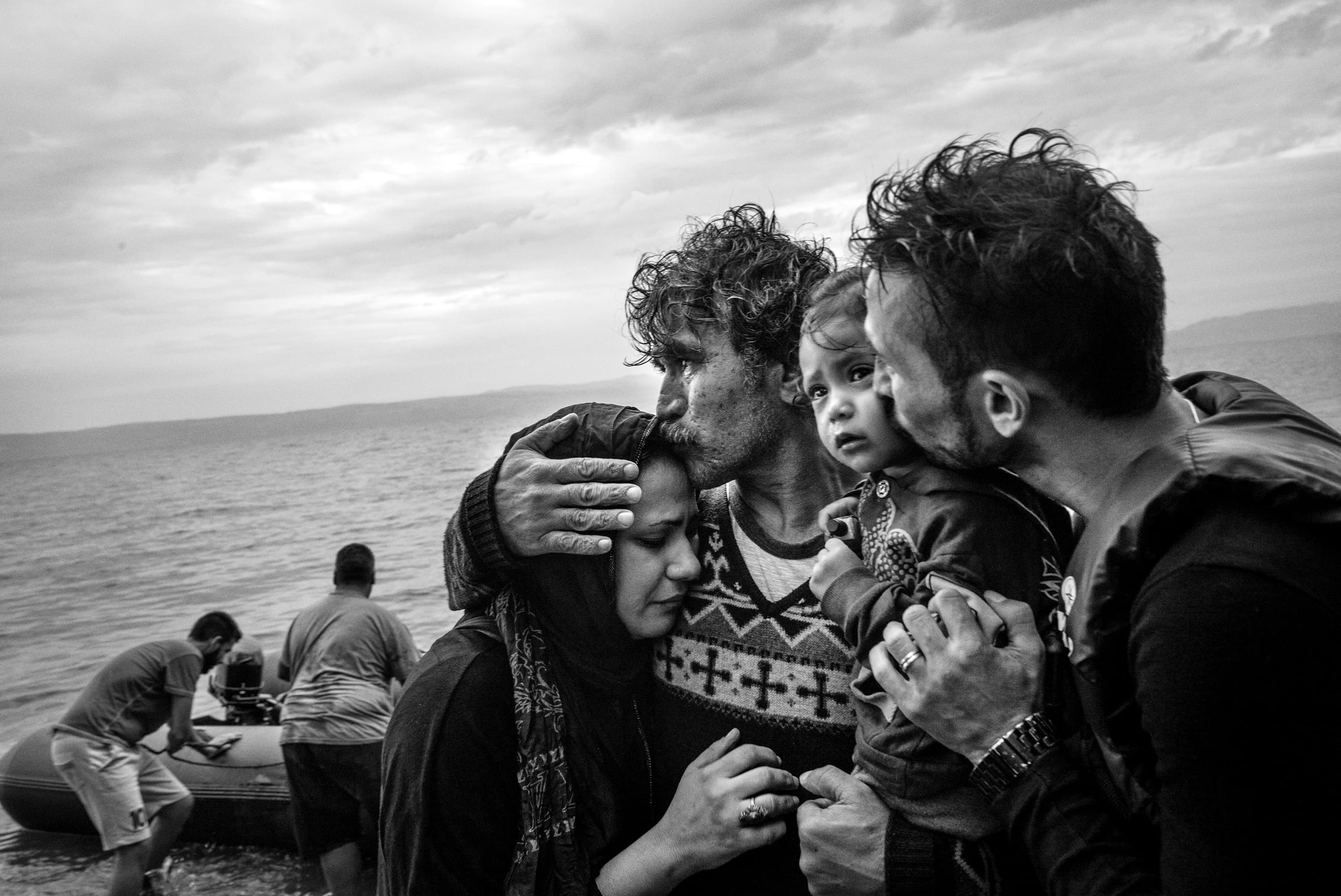 A Syrian family weeps tears of joy after reaching, on a rubber boat from Turkey, the village of Skala Sykaminias  located on the northeastern Greek island of Lesbos, on October 10, 2015. Thousand of refugees, mostly coming from Syria, Iraq and Afghanistan, cross everyday the Aegean sea from Turkey to reach Europe: a relatively short but extremely perilous journey. According to the UN Refugee Agency, more than 850 000 arrivals by sea were registered in Greece in 2015.