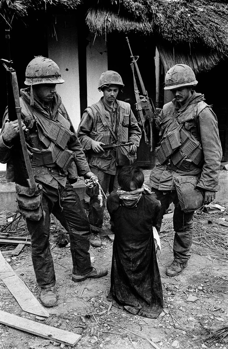 US Soldiers tormenting a civilian in the old city of Hue during the offensive, Tet, Hue, 1968