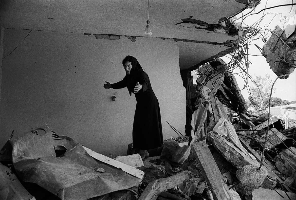 A Palestinian woman returning to the ruins of her house, Sabra, Beirut, 1982