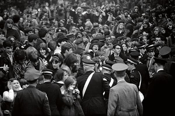 Crowds of fans held back by police, by Gered Mankowitz © Bowstir Ltd/Gered Mankowitz