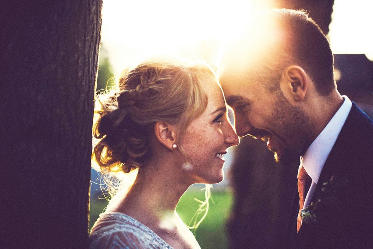 Shoot with the sun behind the couple to avoid squinting eyes and harsh shadows