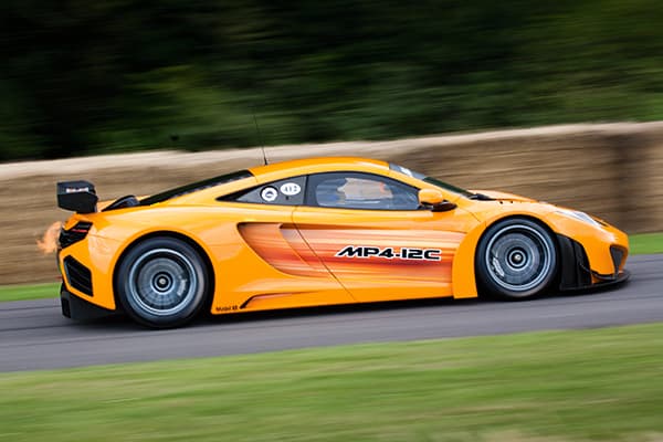 A shutter speed fast enough to keep the vehicle sharp but slow enough to blur the background while panning is the key to getting such an image