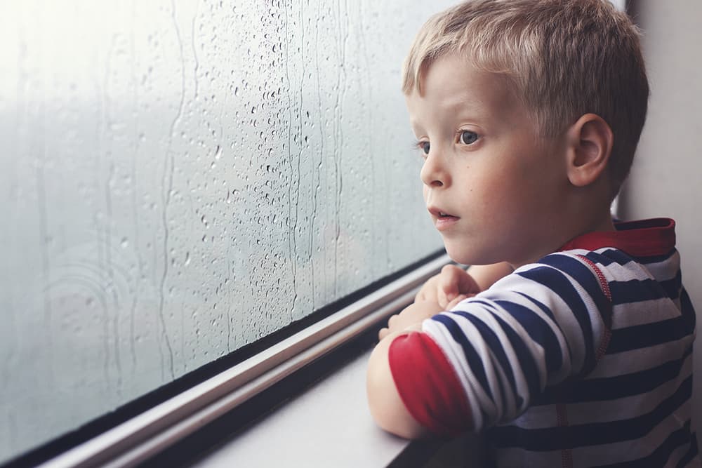Amy Drucker child looking out rainy window
