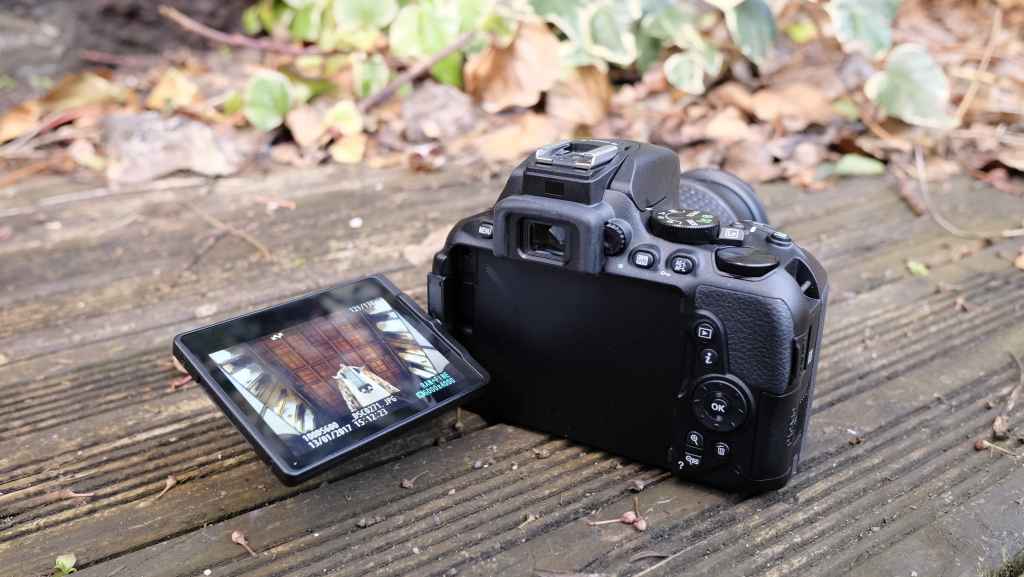 Nikon D5600 with articulating LCD screen tilted out and upwards.