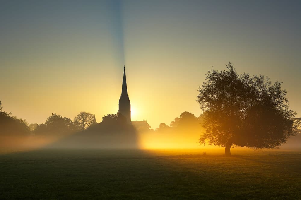 Outdoor light sun rising behind Salisbury Cathedral