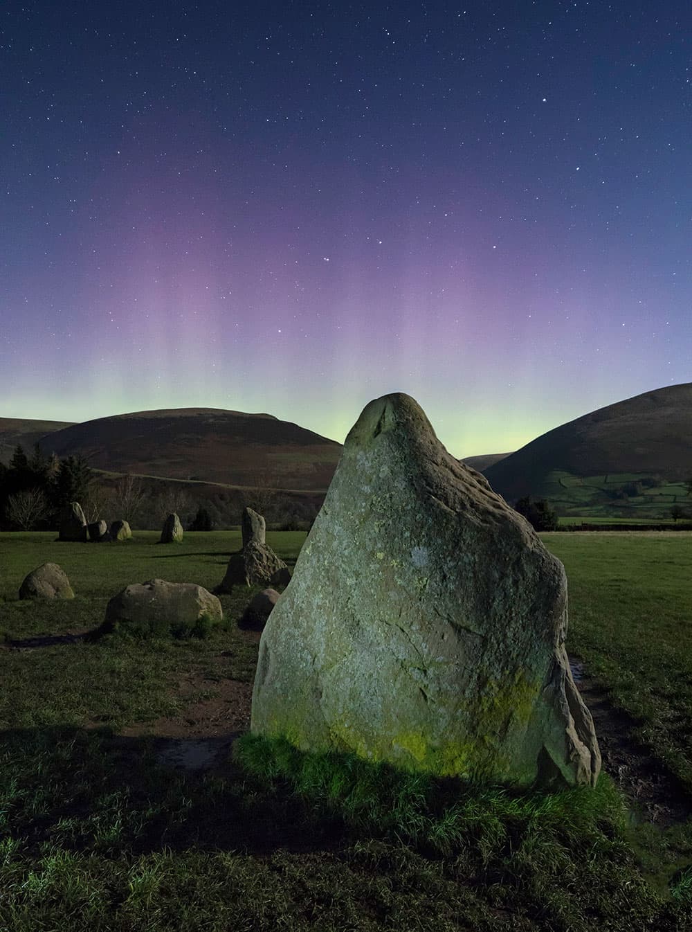 low-light Aurora over Castlerigg Stone Circle