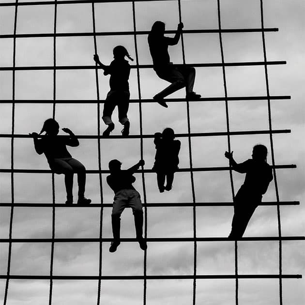 square format photography children climbing on a frame