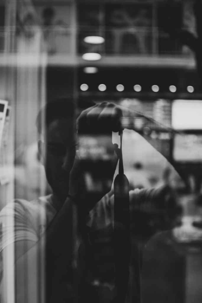 street photographers taking a photo of himself in reflection