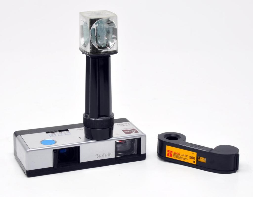 An early Pocket Instamatic 300, pictured with a 110 film cartridge and fitted with its flashcube extender, to help eliminate redeye when shooting with flash
