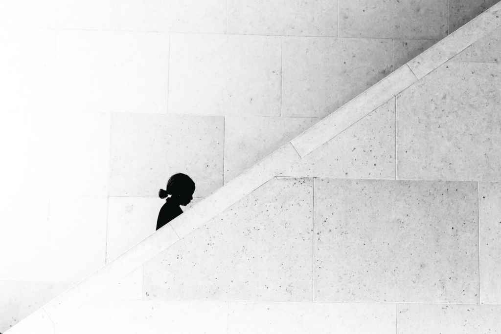 woman silhouette walking up stairs 