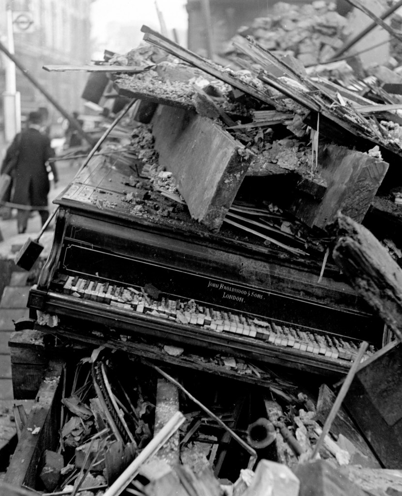Lee Miller’s daily journeys around London during the Blitz yielded some of her most striking Surrealist images. The piano remains relatively intact, but it will be a long time before its music is heard – if indeed it is ever played again. The seeming nonchalance of the pedestrian adds to the dreamlike quality of the picture. The image becomes an icon for the effect of war on culture and civilisation.<br />Published in 'Grim Glory - Pictures of Britain under fire'; edited by Ernestine Carter; preface by Edward R. Murrow; photographs by Lee Miller &amp; others; 1941; published by Lund Humphries/Scribners, London. Fig 73