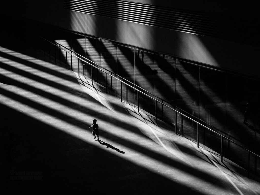 A child runs around whilst bathed in rays of sunlight in the turbine hall. Tate Modern, during a heat wave bank holiday. Bankside, London, UK. May 06, 2018. Photo: Edmond Terakopian