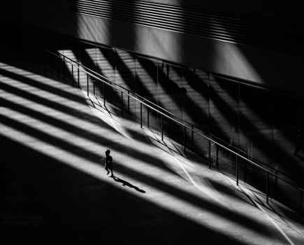 A child runs around whilst bathed in rays of sunlight in the turbine hall. Tate Modern, during a heat wave bank holiday. Bankside, London, UK. May 06, 2018. Photo: Edmond Terakopian