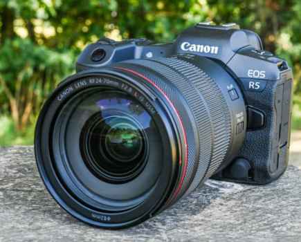Canon EOS SR5 camera in black and red, sat on a stone