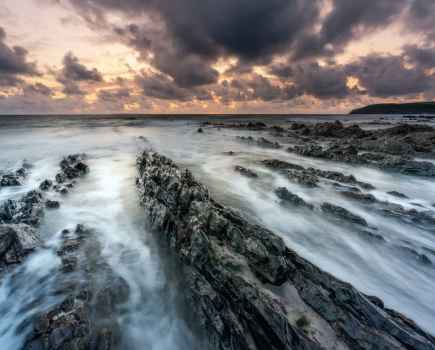 Rocky beach landscape with misty water
