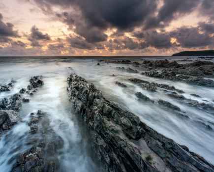 Rocky beach landscape with misty water