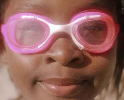 Close up of a young child in pink goggles