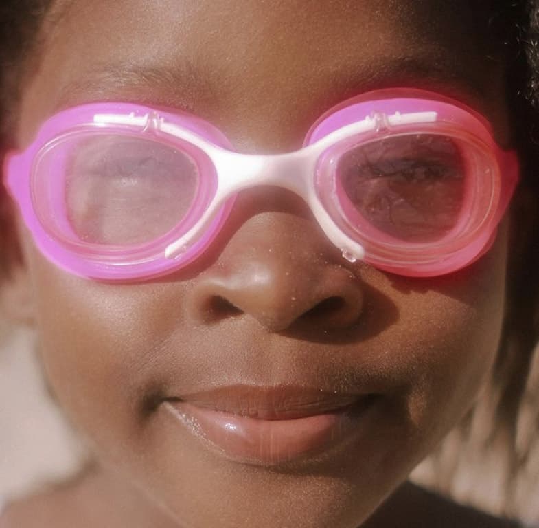 Close up of a young child in pink goggles