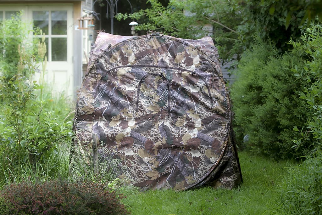 Camouflage tent in a garden.