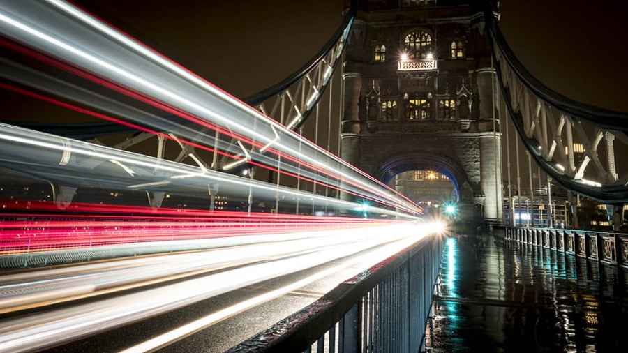Tower bridge at night with the blur of vehicle lights crossing