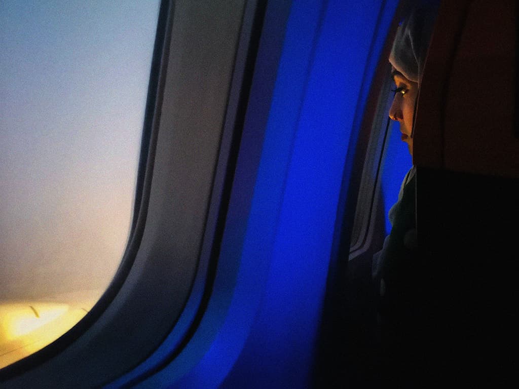 person looking out of plane window