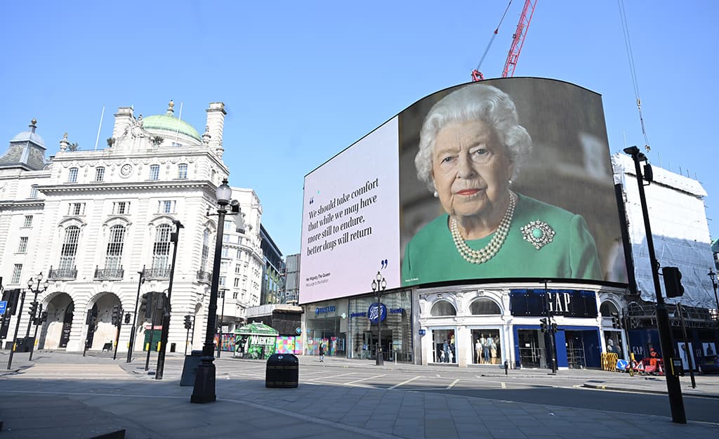 Image of empty piccadilly circus screen showing Queen Elizabeth II during pandemic