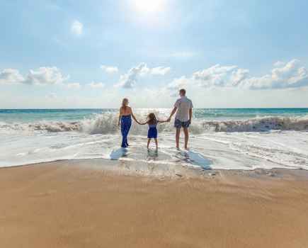 Family on the beach Photo by Natalya Zaritskaya