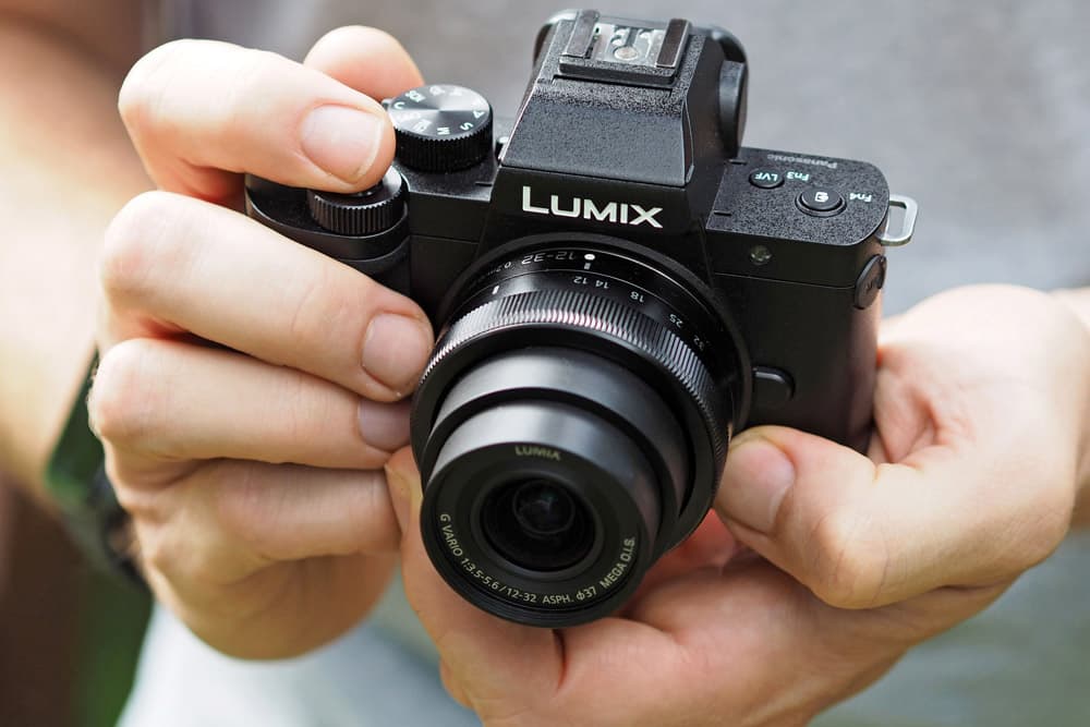 Best cameras for vlogging: Panasonic Lumix G100 in hand