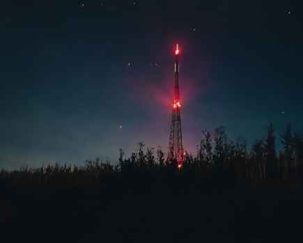 Night capture of a radio tower with red lights