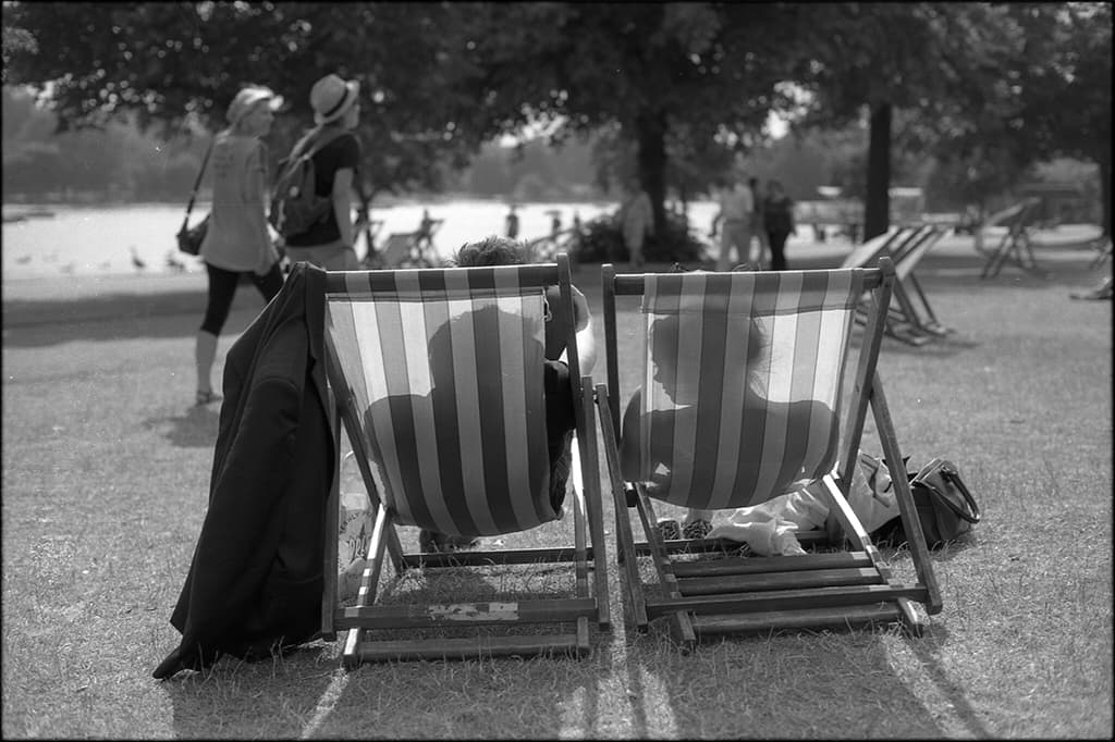 black adn white photo people on deck chairs