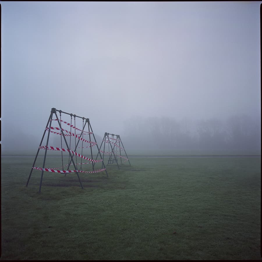 image of a fenced off swing set
