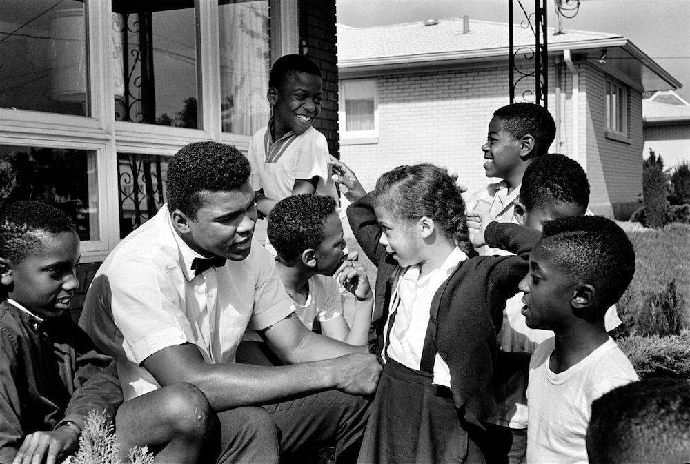 Muhammad Ali pictured with local kids on the porch of his house in Louisville, Kentucky, in May 1963 