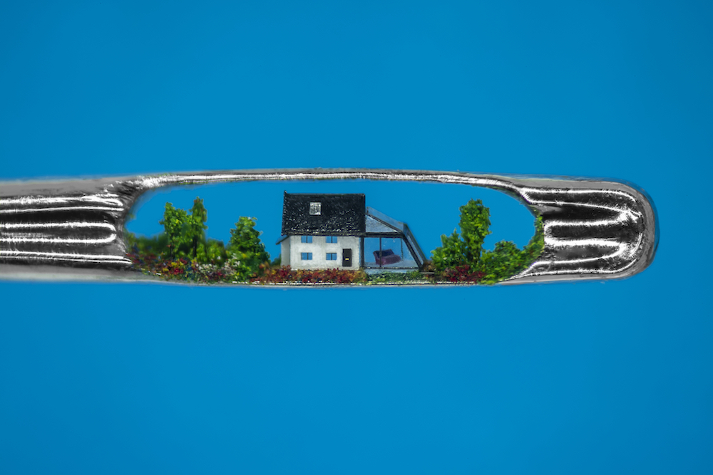 A close-up, shot on the microlens of the OPPO Find X3 Pro smartphone, of a microscopic sculpture of a ‘Little House & Conservatory’ by Dr. Willard Wigan MBE