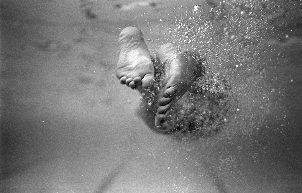 The feet of Olympic swimmer Bobby McGregor kick up a stream of bubbles