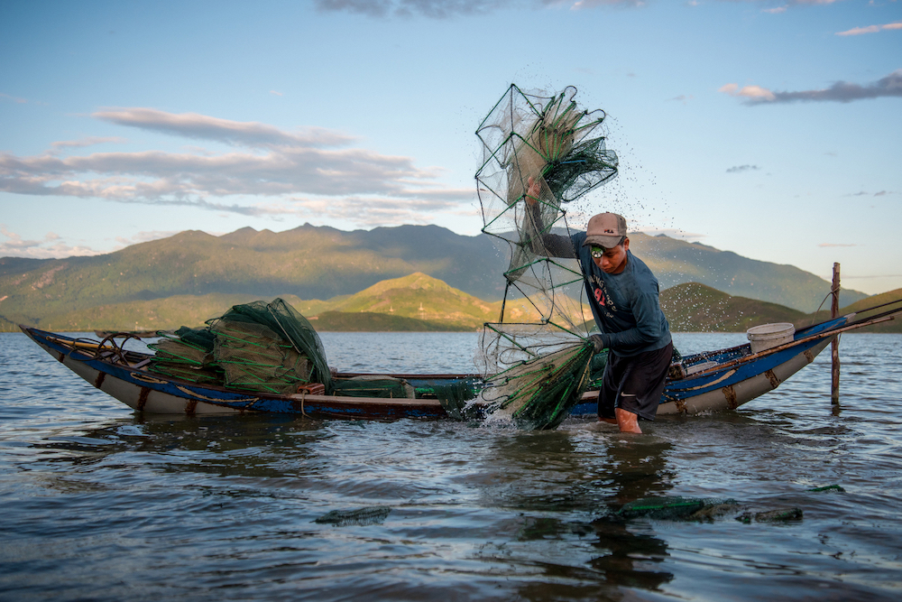 An image by Khanh Bui Phu, joint winner of UP21, showing a boy washing a fish trap after working