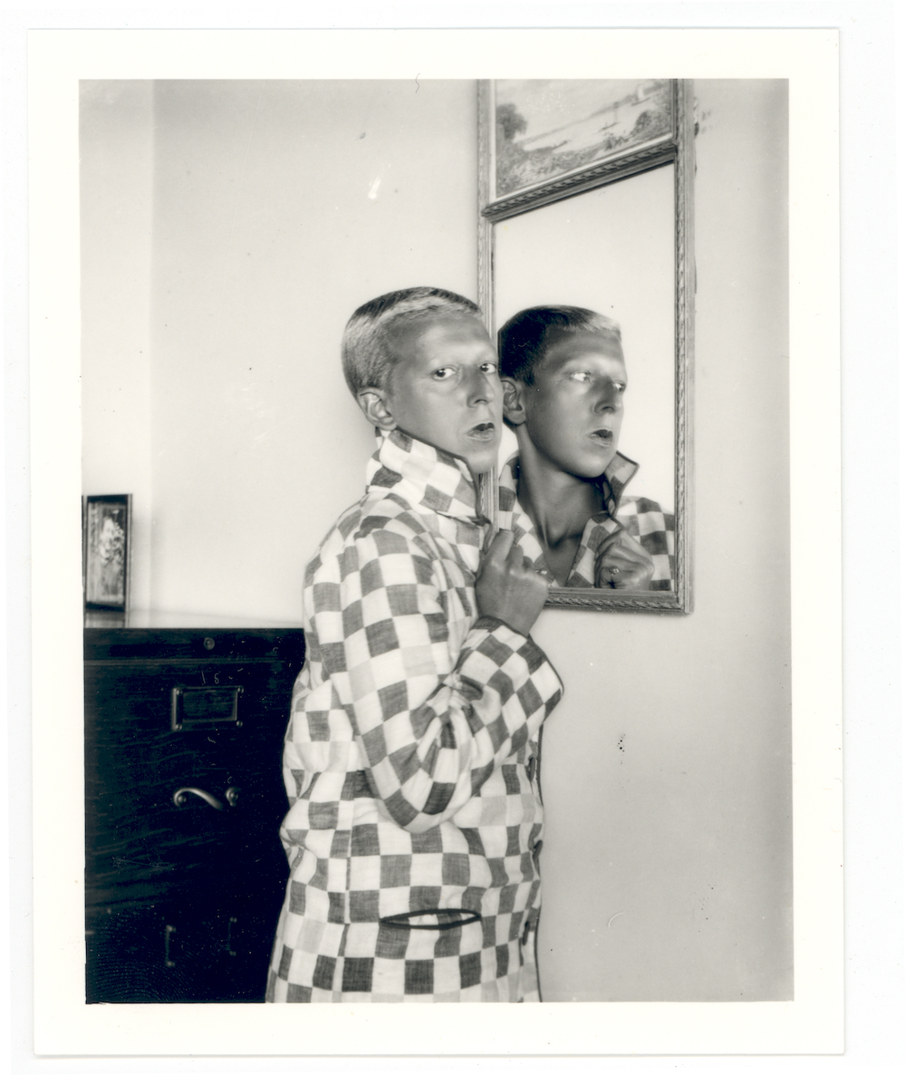 Claude Cahun Self-portrait (reflected image in mirror, chequered jacket) 1928. Image: Courtesy of Jersey Heritage Collections © The estate of Claude Cahun