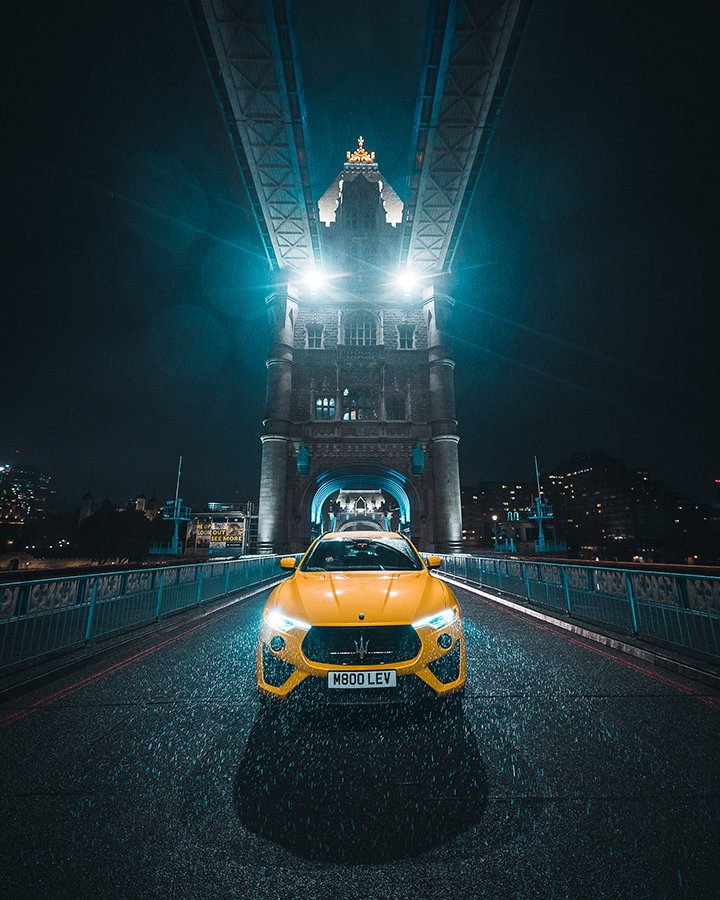 low light urban image yellow car on tower bridge