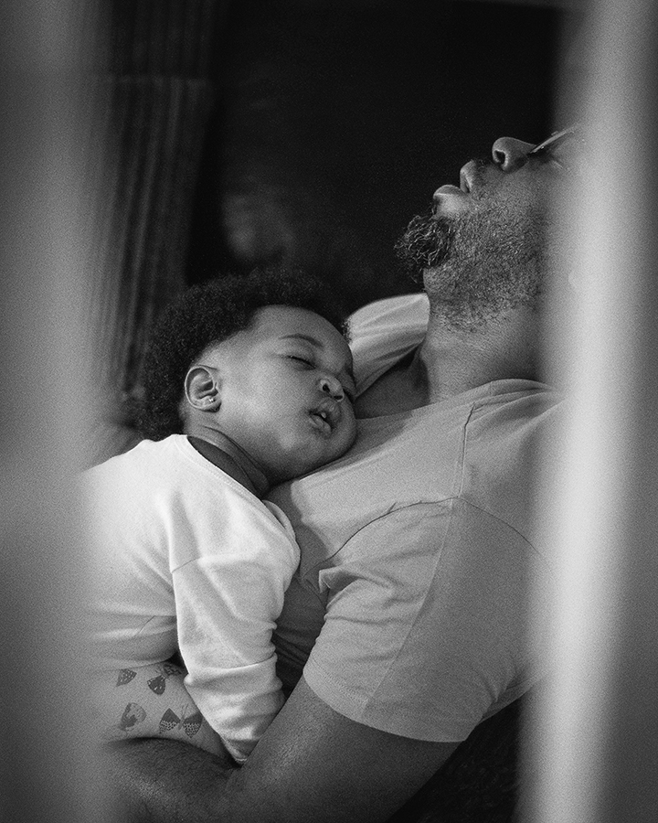 black and white portrait baby sleeping on dad