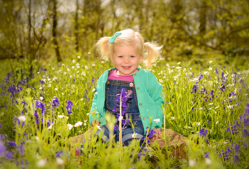 young girl with blonde hair in spring wildflower meadow for portrait photo shoot tips