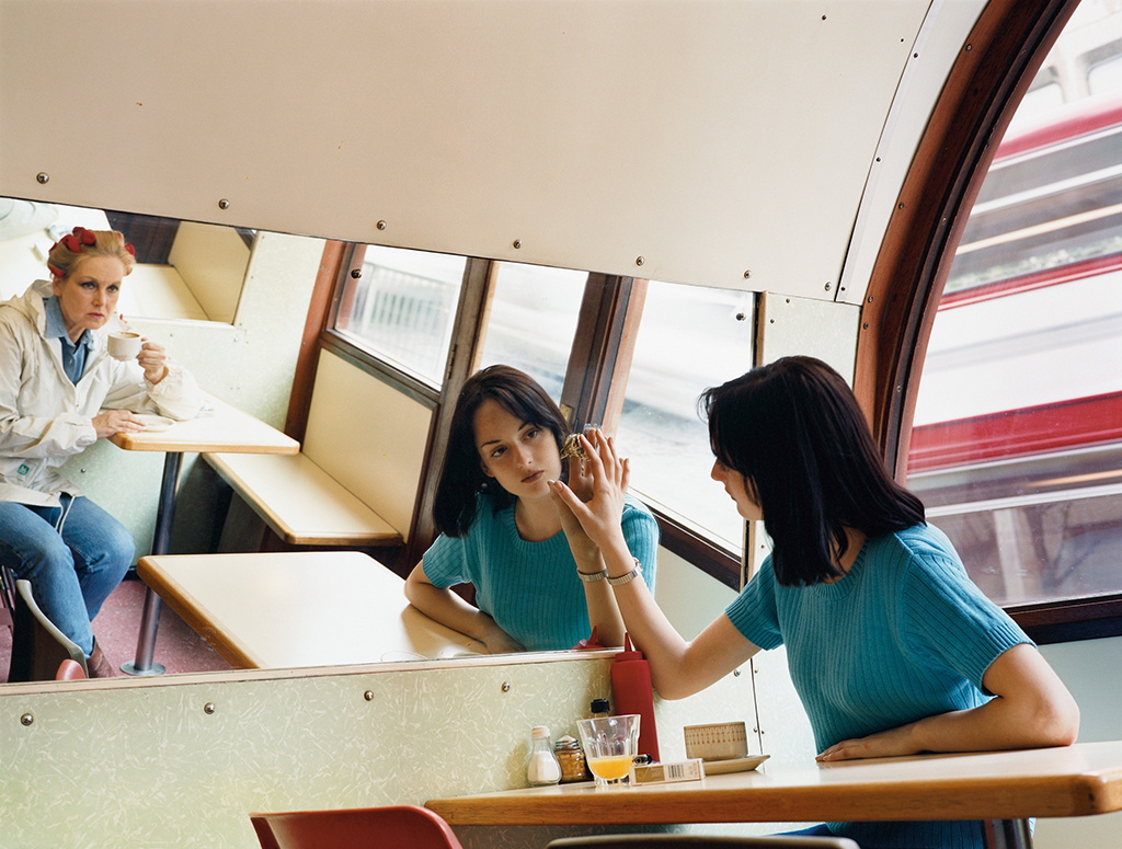 woman looking in a diner mirror 