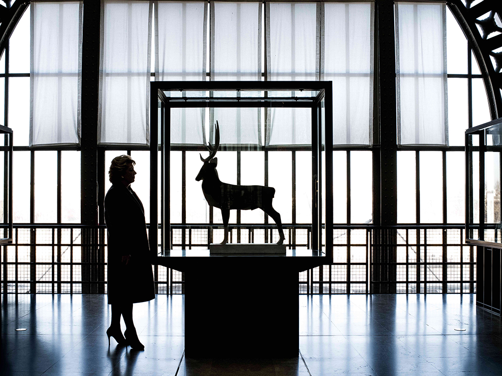 silhouette of woman with stag statue by hannah starkey