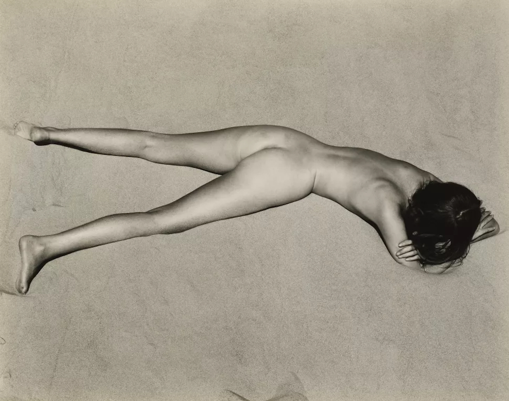 Edward Weston (1886-1958), Nude on Sand, Oceano, 1936. Gelatin silver print, mounted on board, printed 1940s. Image/sheet/mount: 14x15½in. Estimate: $70,000-100,000. Offered in Photographs from the Richard Gere Collection on 23 March-7 April 2022 at Christie's Online