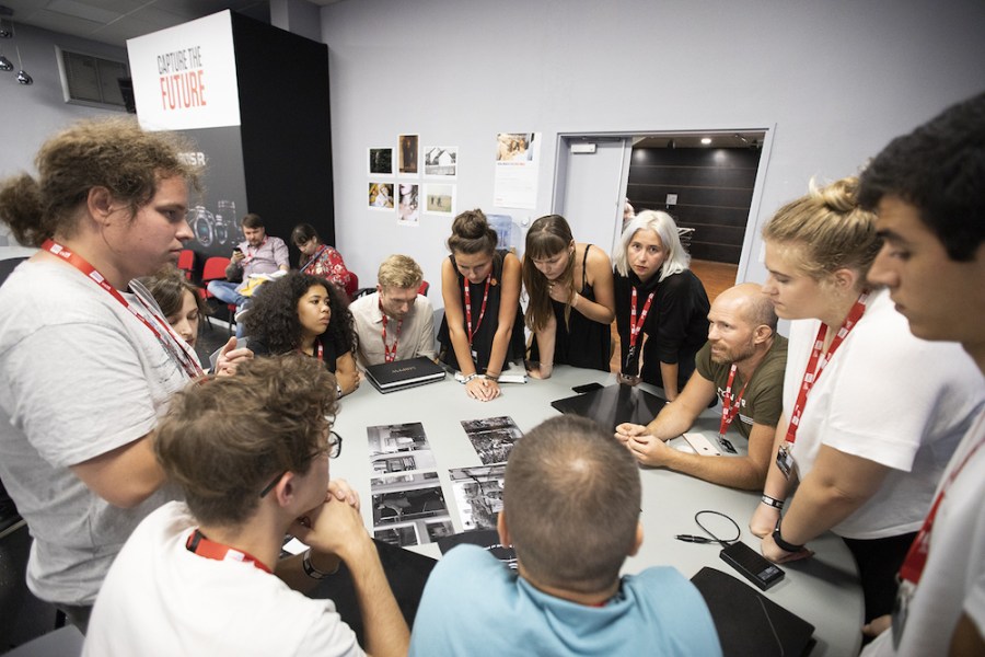 Benoit Baume, right seated, of Fisheye magazine leads a student portfolio review session at Visa pour l'Image 2019. © Paul Hackett