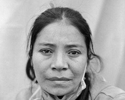 Doris Maria Lara Caballero, age 31, is a migrant from Department Cortés, Honduras. She takes a portrait of herself at the Enrique Romero Municipal Gymnasium in Juárez, Chihuahua, Mexico on 30 April 2021. Series Name: Migrantes. © Adam Ferguson, Australia, Photographer of the Year, Professional, Portraiture, 2022 Sony World Photography Awards